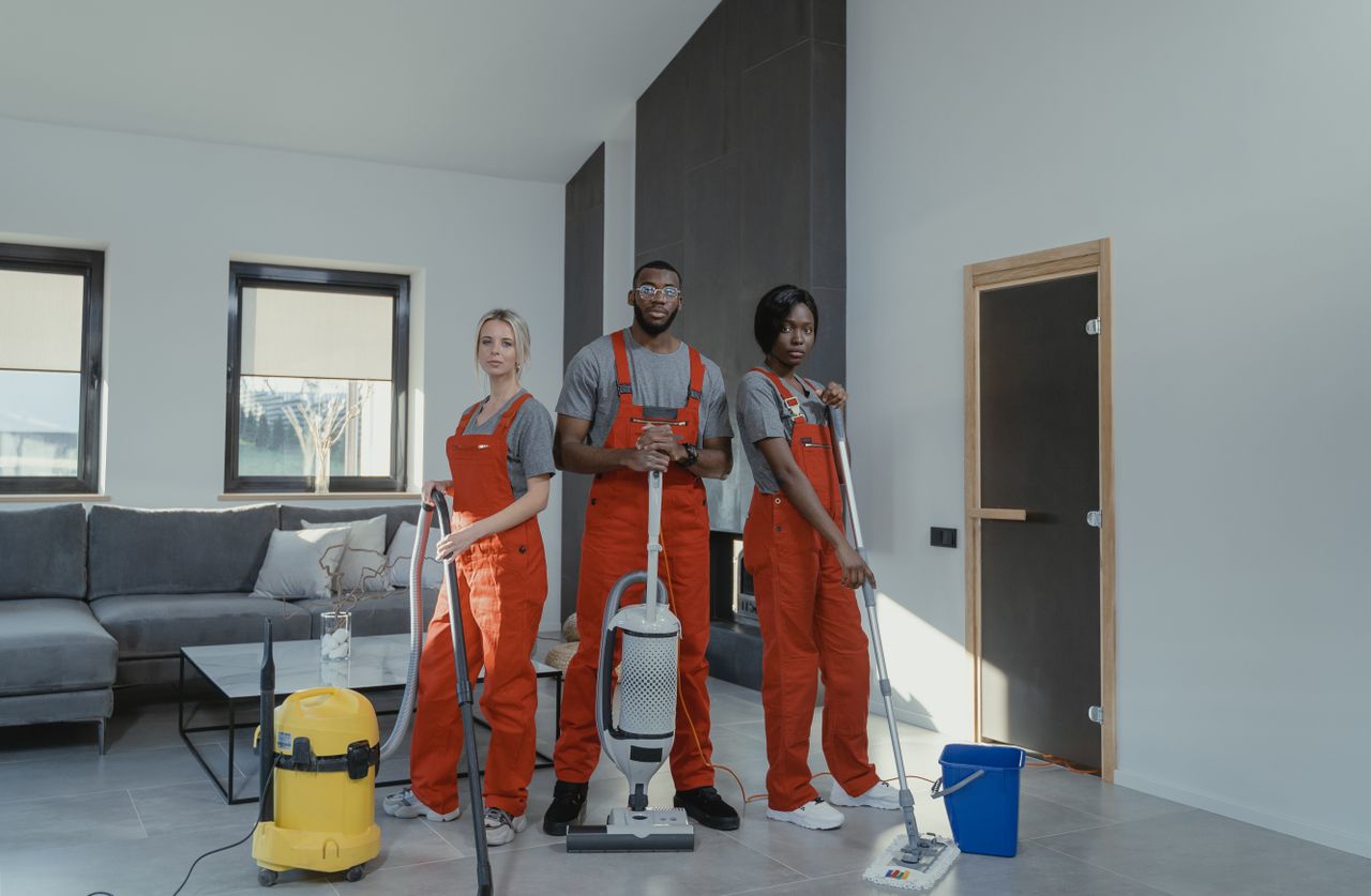 The Scent and Fresh cleaning team standing together in a bright Margate living room, ready to work